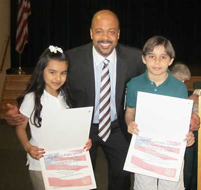 Photo from LBPS Facebook page.  Assistant Superintendent of Schools Alvin L. Freeman with Ericka Ramirez and Gabriel Souza of the Audrey W. Clark School, the two students who led the Flag Salute and Pledge of Allegiance at the March Board of Education Meeting.