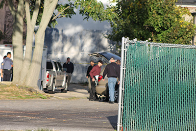 The cororner's office places the body in a station wagon